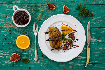 Roasted breast of duck with oranges and figs, rosemary and sage . Top view. 