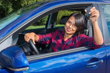 Woman driving car  showing car key