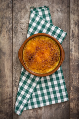 Spanish dessert. Crema catalana on wooden table

