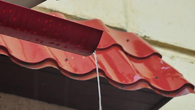Water pouring into gutter during powerful storm