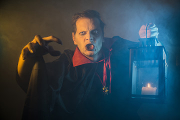 vampire count Dracula waves his hand and shows a scary gesture