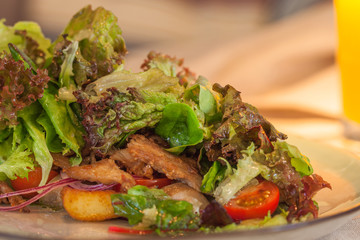 Delicious salad with Turkey, tomatoes and baked potatoes with orange juice