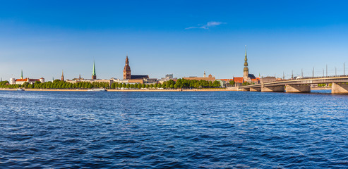 Obraz premium Panoramic view on the embankment of the Daugava River and bridge