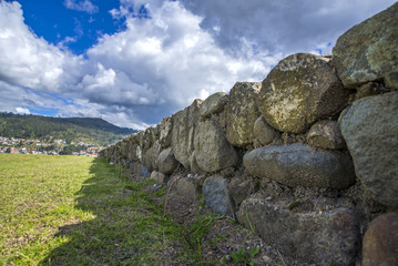 Stone walls of the ancient inca ruin city of Pumapungo, in Cuenca, Ecuador, on a sunny morning