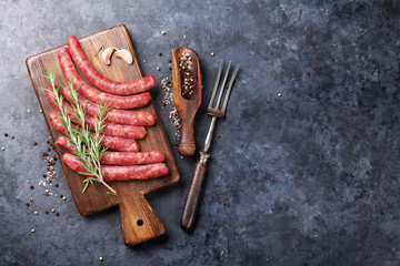 Raw sausages and ingredients for cooking