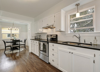 White kitchen storage combination and steel appliances