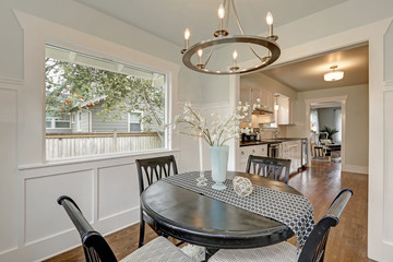 Dining black round table with four cushioned chairs. Dining room