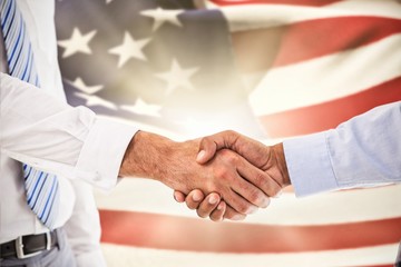 Composite image of close-up shot of a handshake in office - Powered by Adobe