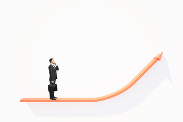 Thoughtful businessman on chart arrow