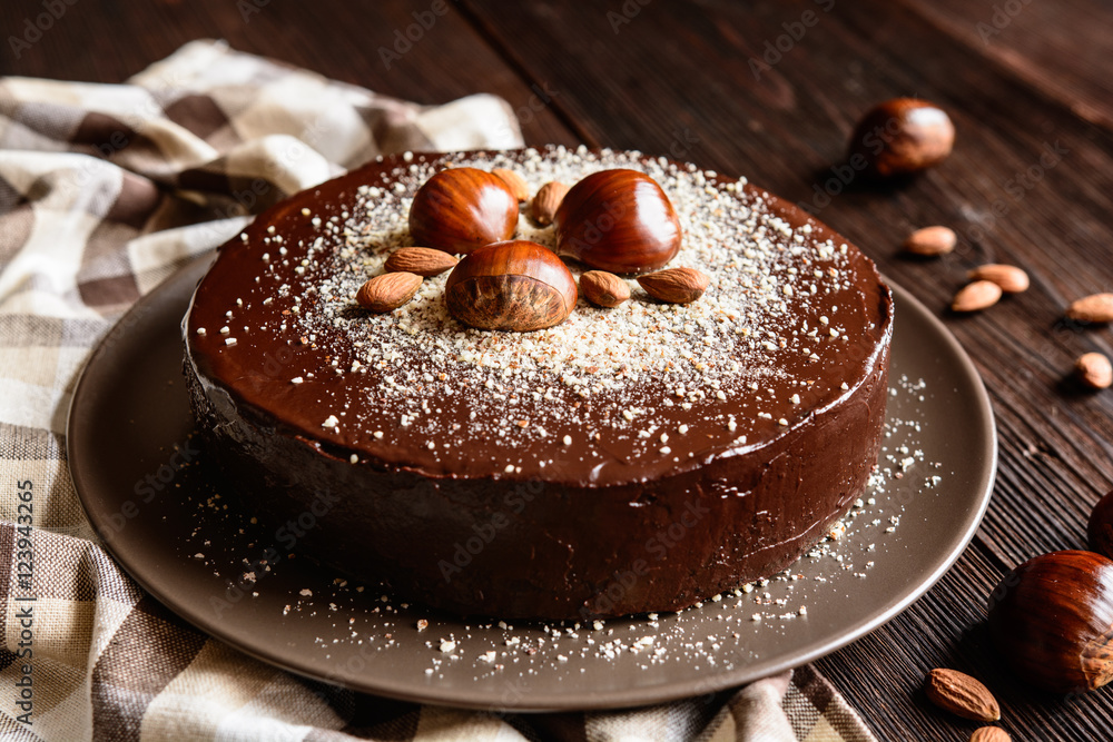 Wall mural Delicious chestnut cake with almonds and chocolate glaze