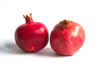 Two pomegranates on a white background