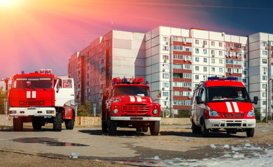 three red fire truck at sunset.