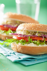 tomato sandwich on bagel with cream cheese onion lettuce alfalfa