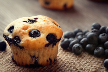 muffin with blueberries on a wooden table. fresh berries and swe