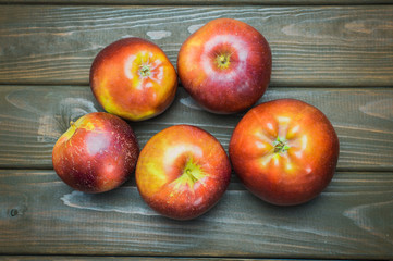 Whole green red ripe apples autumn harvest from above on dark brown wooden table