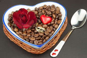 Romantic coffee. Marriage proposal. Coffee beans and a gold ring. Breakfast for lovers. Declaration of love on Valentine's Day.

