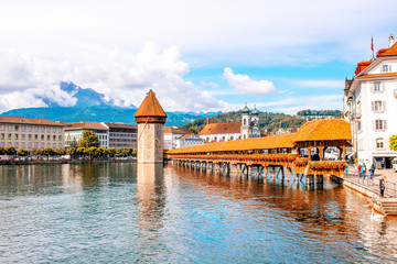Cityscape view on the famous wooden bridge and tower on Reuss river in Lucerne old town in...