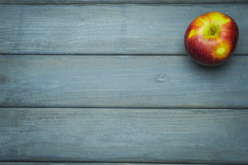 Whole green red ripe apples autumn harvest from above on dark gray blue wooden table