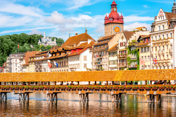 View on the riverside with city hall and old wooden bridge in Lucerne old town in Switzerland