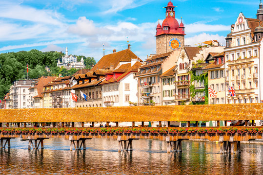 View on the riverside with city hall and old wooden bridge in Lucerne old town in Switzerland
