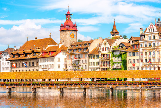 View on the riverside with city hall and old wooden bridge in Lucerne old town in Switzerland
