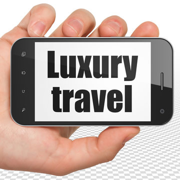 Tourism concept: Hand Holding Smartphone with Luxury Travel on display