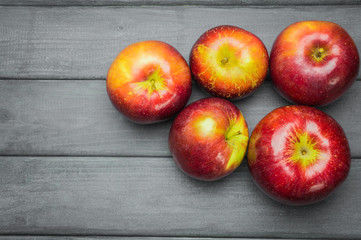 Whole green red ripe apples autumn harvest from above on dark gray blue wooden table