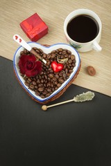 Romantic coffee. Marriage proposal. Coffee beans and a gold ring. Breakfast for lovers. Declaration of love on Valentine's Day.
