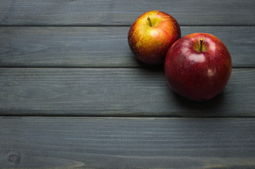 Whole green red ripe apples autumn harvest from above on dark gray blue wooden table