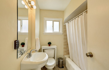 Creamy tones bathroom interior in old craftsman house