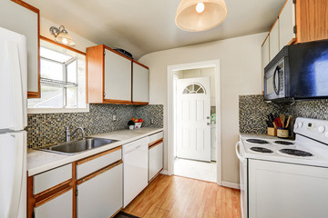Old style kitchen interior with hardwood floor and white appliances
