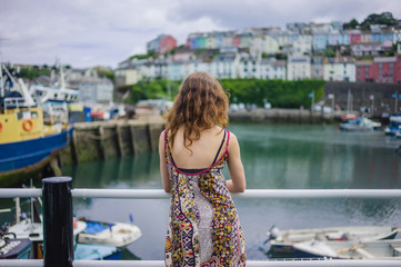 Fototapeta na wymiar Woman standing by railing in harbor