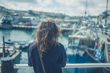 Young woman by fishing boats