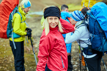 woman hiker photographer taking picture on the mountains background in Iceland