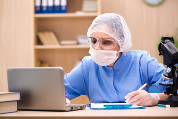 Young woman doctor working in the lab