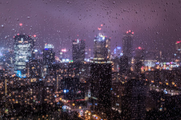 Warsaw, Poland city center through glass window on rainy day