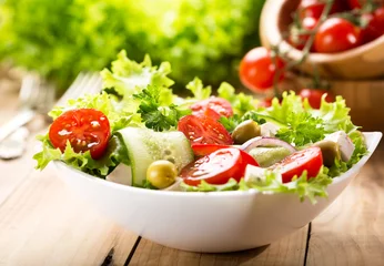 Fototapeten bowl of salad with vegetables and greens © Nitr