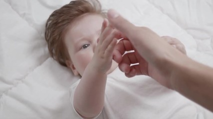 Mother's point of view of her curious baby reaching for her hand.
- Powered by Adobe