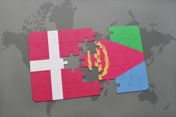 puzzle with the national flag of denmark and eritrea on a world map background.
