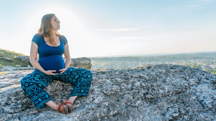 Pregnant Woman Rest in Sunset in Montains