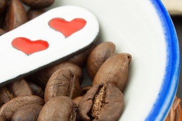 Details of Roasted coffee beans. Close up shot of a pile of roasted coffee beans
