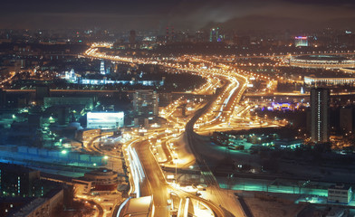 Fototapeta na wymiar Giant automobile overpass at night, view from above in winter. Soft focus