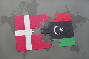 puzzle with the national flag of denmark and libya on a world map background.
