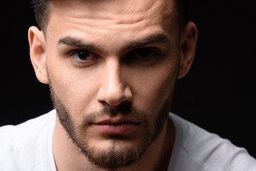 Fototapeta premium portrait of man against black background