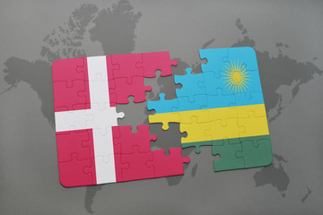 puzzle with the national flag of denmark and rwanda on a world map background.