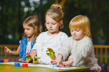Fototapeta premium Children having fun painting with finger paint