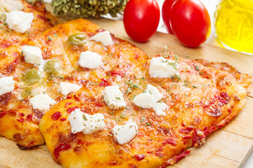 tris of mixed pizza on wood with ingredients