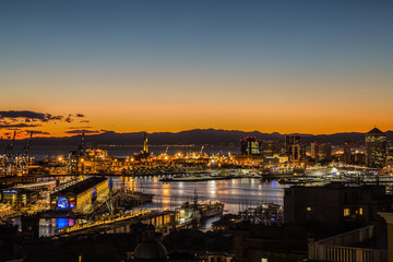 Fototapeta na wymiar GENOA, ITALY, JANUARY 15, 2016: Sunset view of the city of Genoa, Italy/ Genoa landscape/ Genoa Skyline/ city landscape/ aereal view/ light/ city light/ orange/ sunshine