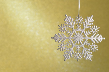 Shimmering diamond beautiful snowflakes on a yellow background.