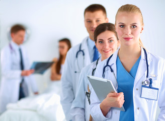 Attractive female doctor in front of medical group
